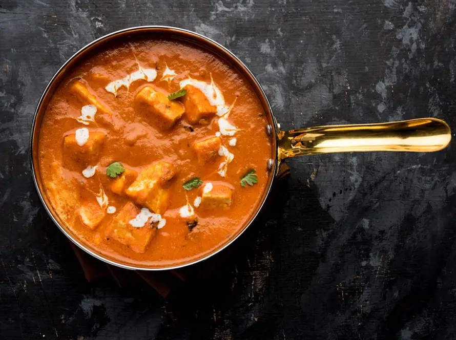 Steaming hot Paneer Butter Masala served with rice and naan, representing the 'Grand Trunk' North Indian Gravies bulk kit for HoReCa supply.