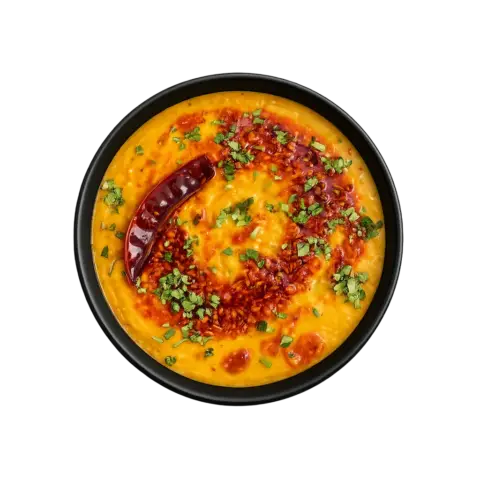 Top view of the North Indian Dal Tadka ready to eat lentil curry in a black bowl