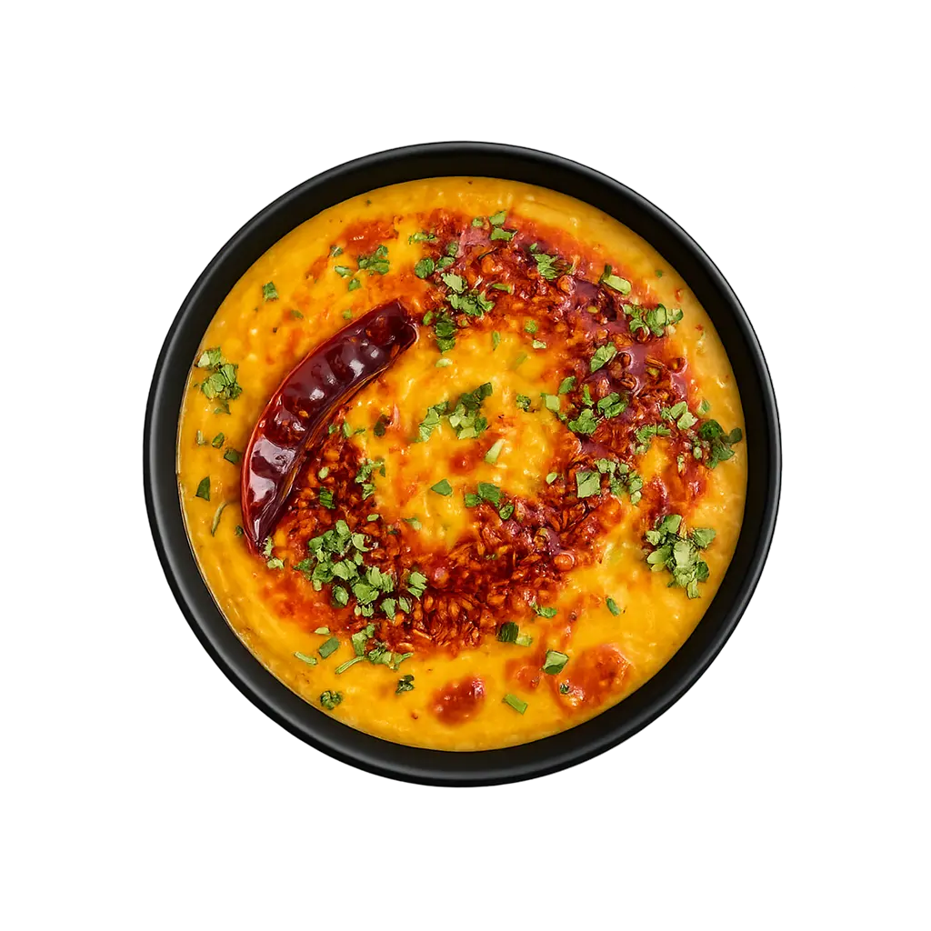 Top view of the North Indian Dal Tadka ready to eat lentil curry in a black bowl