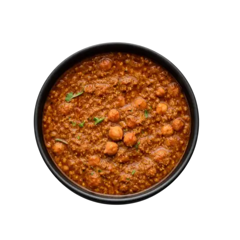 Pot and Ladle Punjabi Chole Masala ready-to-eat product served in a black china bowl with rich chickpea curry