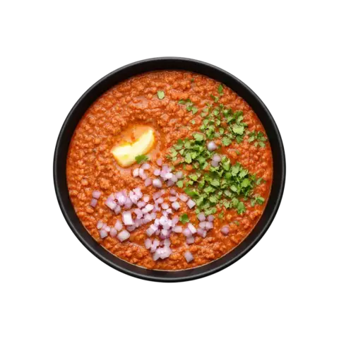 A premium, ready-to-eat serving of Pot and Ladle brand Mumbai-style Pav Bhaji Masala. The 90-degree flat lay shows a black bowl filled with thick, buttery mashed vegetable gravy, topped with melting butter, fresh coriander, and diced onions. The image is captured on a seamless white background for a clean, high-end commercial food aesthetic.