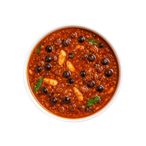 A professional 90-degree top-down flat lay of Pot and Ladle brand ready-to-eat Sundakkai Vatha Kuzhambu. The dark, rich, and thick tamarind gravy is studded with numerous salt-cured and fried turkey berries (sundakkai vathal). The dish has a glossy sheen from gingelly oil and is tempered with mustard seeds, fenugreek, and crisp curry leaves, served in a minimal white bowl on a seamless white background.