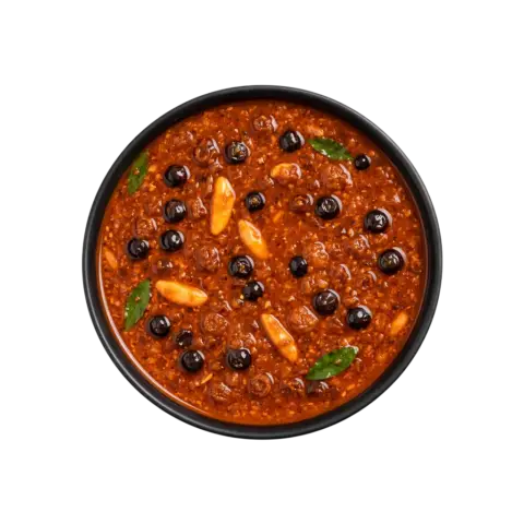 A professional 90-degree top-down flat lay of Pot and Ladle brand ready-to-eat Sundakkai Vatha Kuzhambu. The dark, rich, and thick tamarind gravy is studded with numerous salt-cured and fried turkey berries (sundakkai vathal). The dish has a glossy sheen from gingelly oil and is tempered with mustard seeds, fenugreek, and crisp curry leaves, served in a minimal black bowl on a seamless white background.