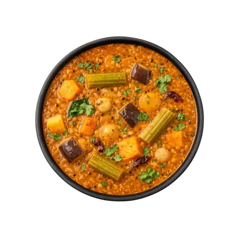 A professional 90-degree top-down flat lay of Pot and Ladle brand ready-to-eat Thanjavur-style Vegetable Sambar. The thick, aromatic orange-brown lentil gravy is loaded with a medley of vegetables including drumsticks, carrots, pumpkin, and beans. The dish is finished with a fragrant tempering of mustard seeds, curry leaves, and a hint of asafoetida, served in a minimal black bowl on a seamless white background.